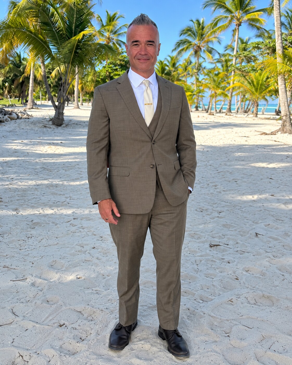 Terry after his transformation, standing on a tropical beach in a fitted brown suit