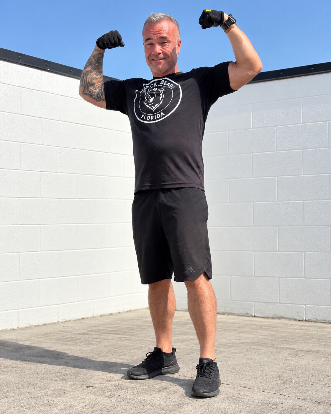 Terry after his transformation, standing outside and flexing
